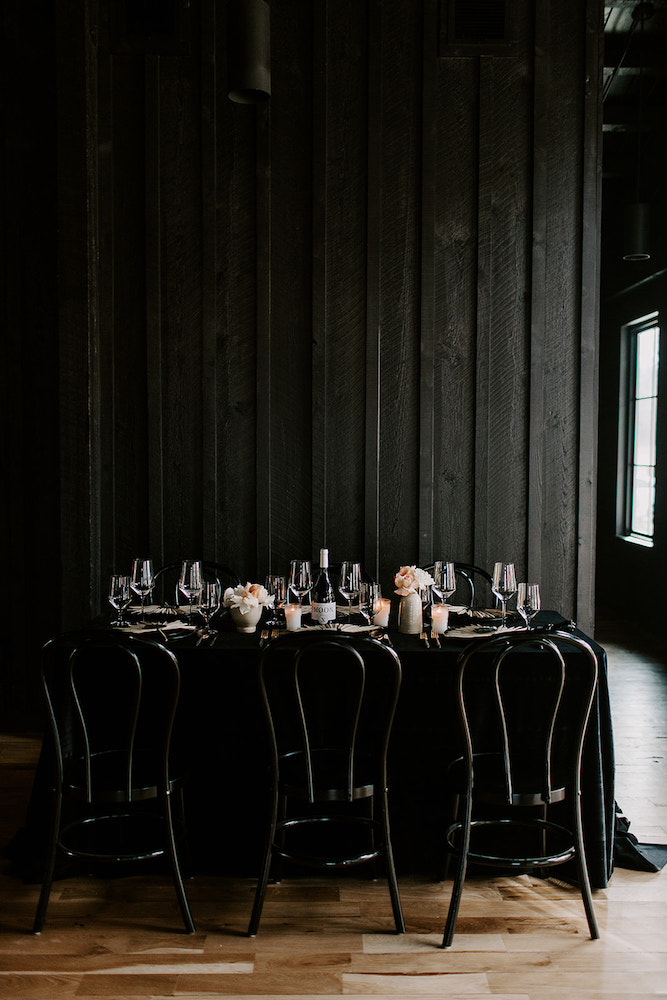 Black moody wedding table with velvet tablecloth