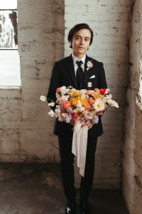 Groom holding bouquet from Fleurish