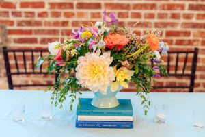 Bright flowers on stack of books Ravington wedding