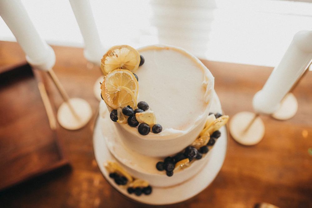 White buttercream frosting wedding cake with lemon slices and blueberries by The Cake Occasion in Fayetteville Arkansas