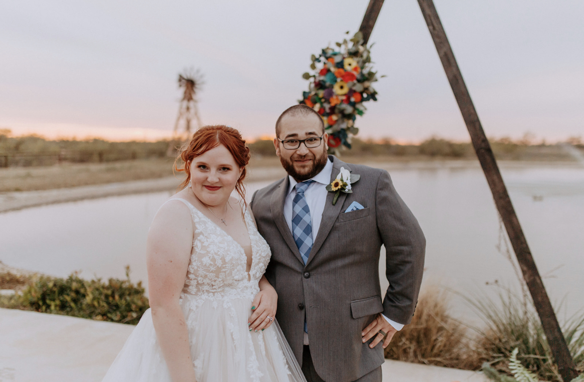 Wedding couple at twin lakes in lubbock texas in front of windmill