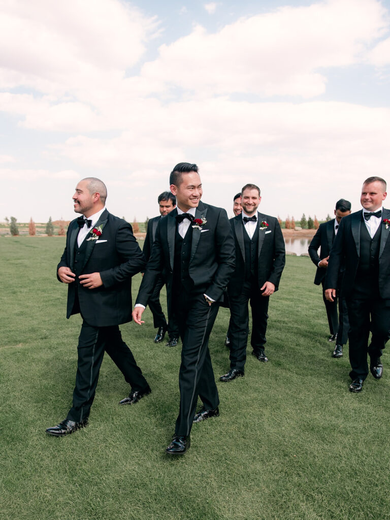 Lubbock groom in tuxedo with red boutonierre