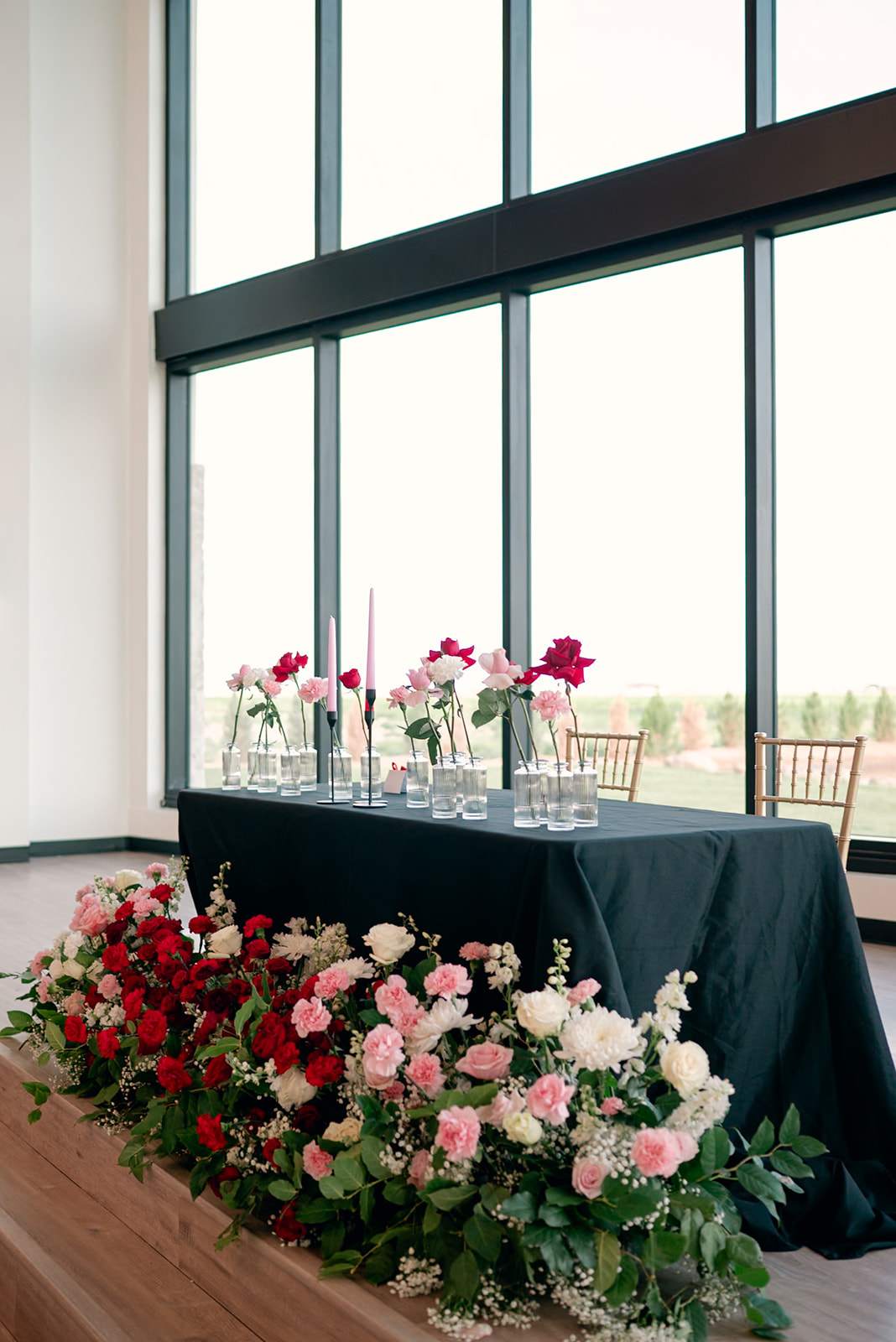 DIY wedding with flowers in front of sweetheart table