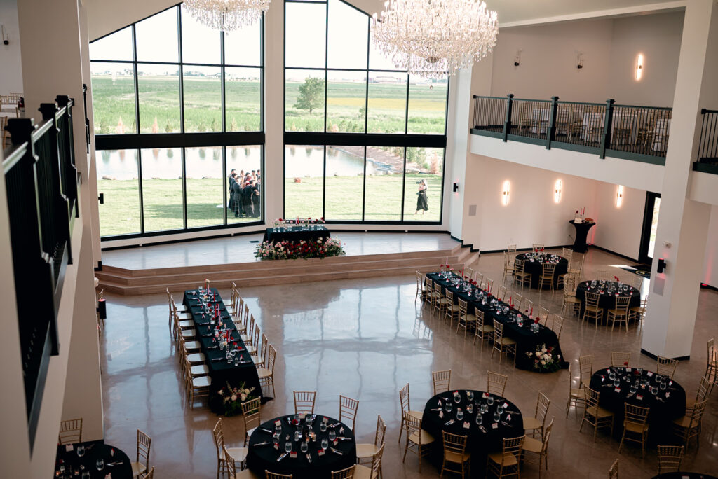 Black, red, pink, and white wedding table with gold in ballroom